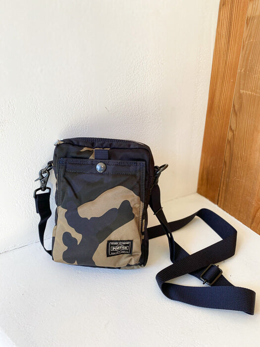 Porter COUNTERSHADE Shoulder Bag Vertical (woodland khaki) - Cotton Sheep About Counter Shade Series Developed in 1981, the COUNTER SHADE series features a Porter original camouflage pattern inspired by coniferous forests. The textile is unique for its color ways including light khaki green, dark forest green, navy, and charcoal. The name ‘counter shade’ represents the designer's use of shadows.
