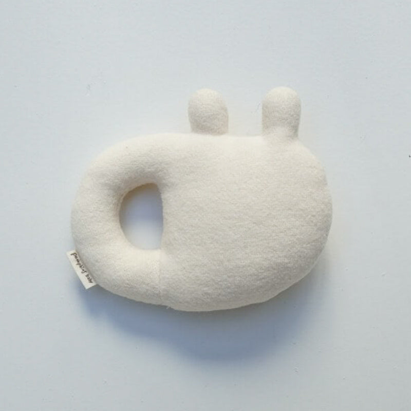 A super soft, and gentle baby rattle with gender-neutral colors that makes the perfect first toy for any newborn.   *If you would like this toy gift-wrapped, please add (free) gift wrap to the order at the top menu bar* Cream colored with red stitching   100% organic cotton Made in Japan