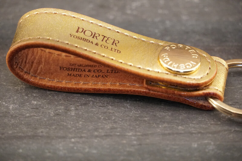 Porter Foil Key Holder About Porter Created in 1935 by Kichizo Yoshida, Porter Yoshida Kaban has been producing timeless and functional bags that are built to last. As Porter continues to grow as a global force, they remain devoted to all products being handmade in Japan by one craftsman from beginning to end. Their devotion to quality and ‘spirit into every stitch’ is why Porter is an iconic Japanese staple amongst businessmen, adventurers, and fashion lovers.