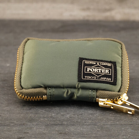 Porter Tanker Key Case About Porter Created in 1935 by Kichizo Yoshida, Porter Yoshida Kaban has been producing timeless and functional bags that are built to last. As Porter continues to grow as a global force, they remain devoted to all products being handmade in Japan by one craftsman from beginning to end. Their devotion to quality and ‘spirit into every stitch’ is why Porter is an iconic Japanese staple amongst businessmen, adventurers, and fashion lovers. 