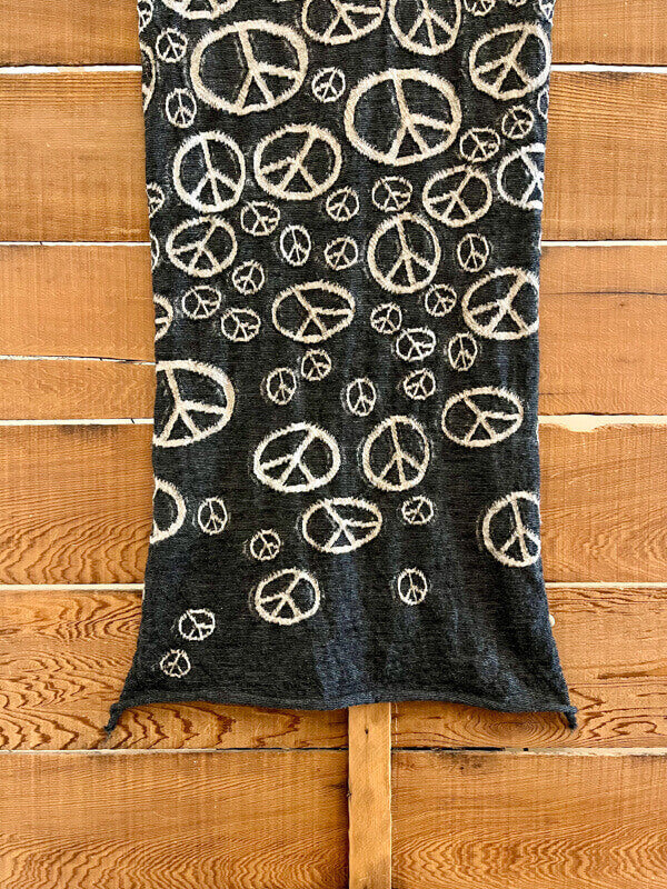 Kapital Peace Mark Scarf, Black, Cream A simple scarf with an all-over peace symbol print ☮︎ 74 in x 17.7 in 100% Wool Made in Japan Additional info About Kapital In 1985 Toshikiyo Hirata started a denim factory in Kojima, Okayama the denim capital of Japan. In 2002, Toshikiyo’s son Kiro Hirata joined his father’s denim factory and revolutionized the business into the iconic fashion brand that Kapital is today. Kapital is inspired by Americana, traditional Japan, and the